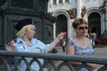 The policewoman indicates the direction of the tourist