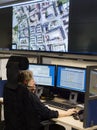 Policewoman at surveillance control center vertical Royalty Free Stock Photo