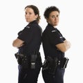 Policewomen back to back. Royalty Free Stock Photo