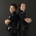 Policewomen back to back. Royalty Free Stock Photo