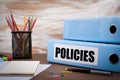 Policies, Office Binder on Wooden Desk. On the table colored pen Royalty Free Stock Photo