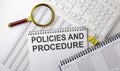 POLICIES AND PROCEDURE text written on a notebook on chart with keyboard and planning Royalty Free Stock Photo