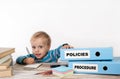 Policies and Procedure - young boy with stack of two office bind Royalty Free Stock Photo