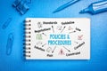 Policies and Procedures Concept. Chart with keywords and icons. Blue office desk Royalty Free Stock Photo