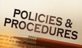 Policies and procedures memo on notebook with pen. Business concept Royalty Free Stock Photo