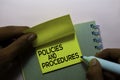 Policies and Procedures text on sticky notes isolated on office desk