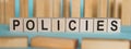 POLICIES - word written on wooden blocks on light blue background