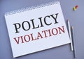 Policy Violation text written on Notebook. Bussines concept meaning the violation of any applicable law or college policy