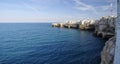 Suggestive landscape view on dramatic cliffs with caves rising from Adriatic sea in Polignano a Mare