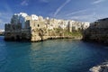 Suggestive landscape view on dramatic cliffs with caves rising from Adriatic sea in Polignano a Mare