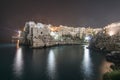 Polignano a Mare, Puglia - Italy. Night at Cala Paura gulf with Bastione di Santo Stefano and Lama Monachile beach on background Royalty Free Stock Photo