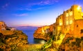 Polignano a Mare, Puglia, Italy: Sunrise at Cala Paura gulf with Bastione di Santo Stefano and Lama Monachile beach Royalty Free Stock Photo