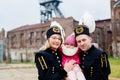 Polish black coal miners family in gala uniforms with child.