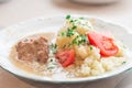 Polish dish bitki wolowe with sauce, smashed potatoes with parsley and tomato