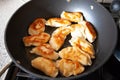 Polish dish pirogi in frying pan. Preparing traditional polish meal pirogi. Food preparing conceptual images.