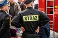 Polish fireman, anonymous firefighter in a uniform back closeup, fire brigade emergency response services concept, news editorial