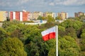 Polish flag in the background of greenery on sunny day