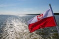 Polish flag suspended on the stern of a small inland ship. A vessel floating on a large lake in central Europe Royalty Free Stock Photo