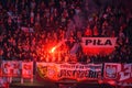 Polish football fans of team Poland at tribune with red fire