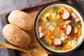 Polish Grochowka Pea soup with potatoes, onions, carrots, bacon and sausages close-up in a bowl. Horizontal top view Royalty Free Stock Photo