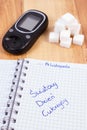 Polish inscription world diabetes day in notebook, glucometer and sugar cubes