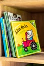 Polish Kicia Kocia book for kids about a cat and tractor on a wooden shelf
