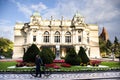 Polish men and Pole women people lovers walking and pushing bicycle passed garden of juliusz slowacki theatre in Krakow Old Town Royalty Free Stock Photo