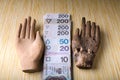 Polish money covered with a wooden hand Royalty Free Stock Photo