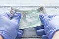 Poland money, one hundred zlotys banknotes kept in rubber gloves. The concept of economy and financial threats during the Coronav