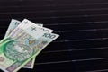 Polish money on solar panel surface. Renewable energy cost Royalty Free Stock Photo