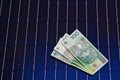 Polish money on solar panel surface. Renewable energy cost Royalty Free Stock Photo