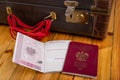 Polish passport and travel suitcase on a wooden table. Accessories for the traveler before the international trip