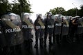 Polish policemen in action, white helmets, plastic covers