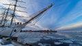 Polish sailing ship SV Dar Mlodziezy at the waterfront in Gdynia in winter time. Amazing pink blue white sky.