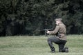 Polish soldier firing burst from Thompson machine gun during historical reenactment of WWII Royalty Free Stock Photo