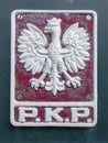 Polish State Railway (PKP) emblem with white eagle on red background.