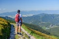 Polish Tatra Mountains, a young man in shorts and a cap with a mountain backpack stands on a mountain trail Royalty Free Stock Photo