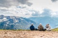 Polish Tatras Poland June 3 2019: elderly people with backpacks are sitting on the ground high in the mountains. An old man looks Royalty Free Stock Photo