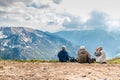 Polish Tatras Poland June 3 2019: elderly people with backpacks are sitting on the ground high in the mountains. An old man looks Royalty Free Stock Photo