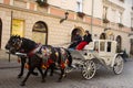 Polish wait and ride horse drawn carriages for Pole people and foreigner travelers use service tour Krakow Old Town in Main Market Royalty Free Stock Photo