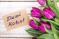 Polish Women`s Day card and a bouquet of beautiful tulips on wooden background Royalty Free Stock Photo