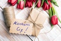 Polish word LOVE and bouquet of tulips Royalty Free Stock Photo