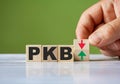 Polish word PKB english GDP symbol concept and hand turn wooden block and change red arrow