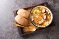 Polish Zupa grochowa Pea soup with vegetables, bacon and sausages close-up in a bowl. Horizontal top view Royalty Free Stock Photo