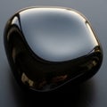 A polished, black obsidian stone with a smooth, reflective surface. Its rounded, Royalty Free Stock Photo
