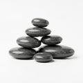 Polished black stones arranged in a pyramid shape on a plain white Royalty Free Stock Photo
