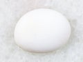 polished cacholong (white opal) gemstone on white