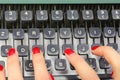 polished fingernails of secretary typing on the keys of an old typewriter in an office Royalty Free Stock Photo