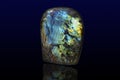 Polished gemstone labradorite labrador stone on dark background Royalty Free Stock Photo