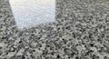 Polished granite countertop featuring a speckled pattern of gray, black, and white. The surface is Royalty Free Stock Photo
